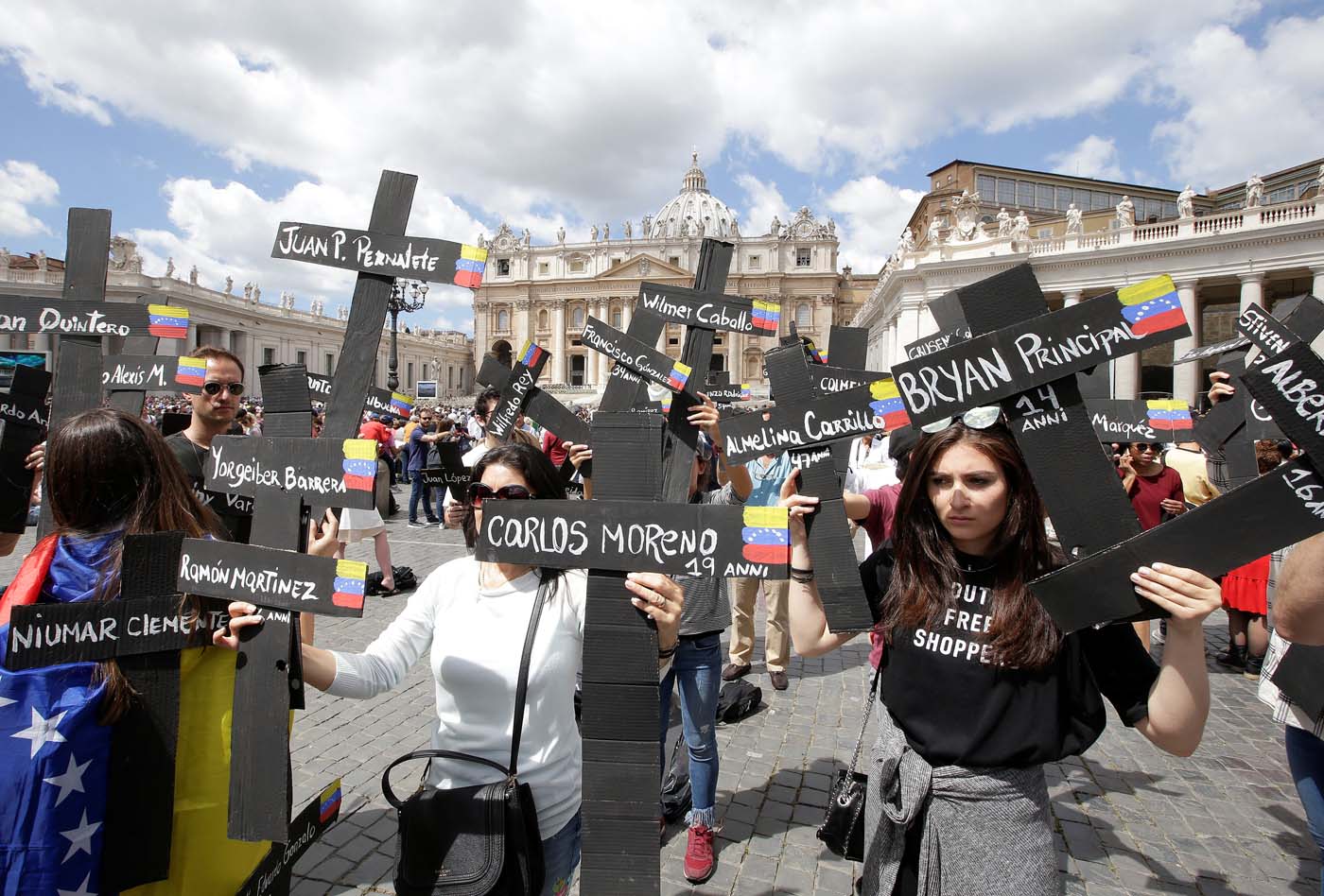 The faithful from Venezuela hold crosses with names of people who died during protests in Venezuela, before the Regina Coeli prayer led by Pope Francis in Saint Peter's Square at the Vatican May 7, 2017. REUTERSMax Rossi