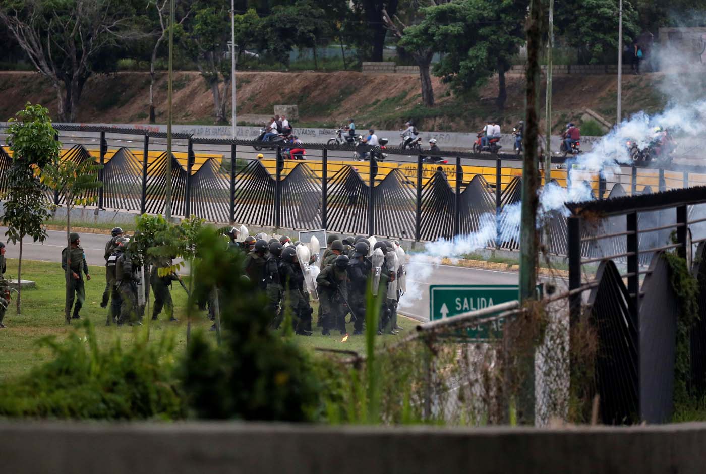 Military police take position at an air base as opposition supporters clash with them while rallying against President Nicolas Maduro in Caracas, Venezuela, May 8, 2017. REUTERS/Carlos Garcia Rawlins