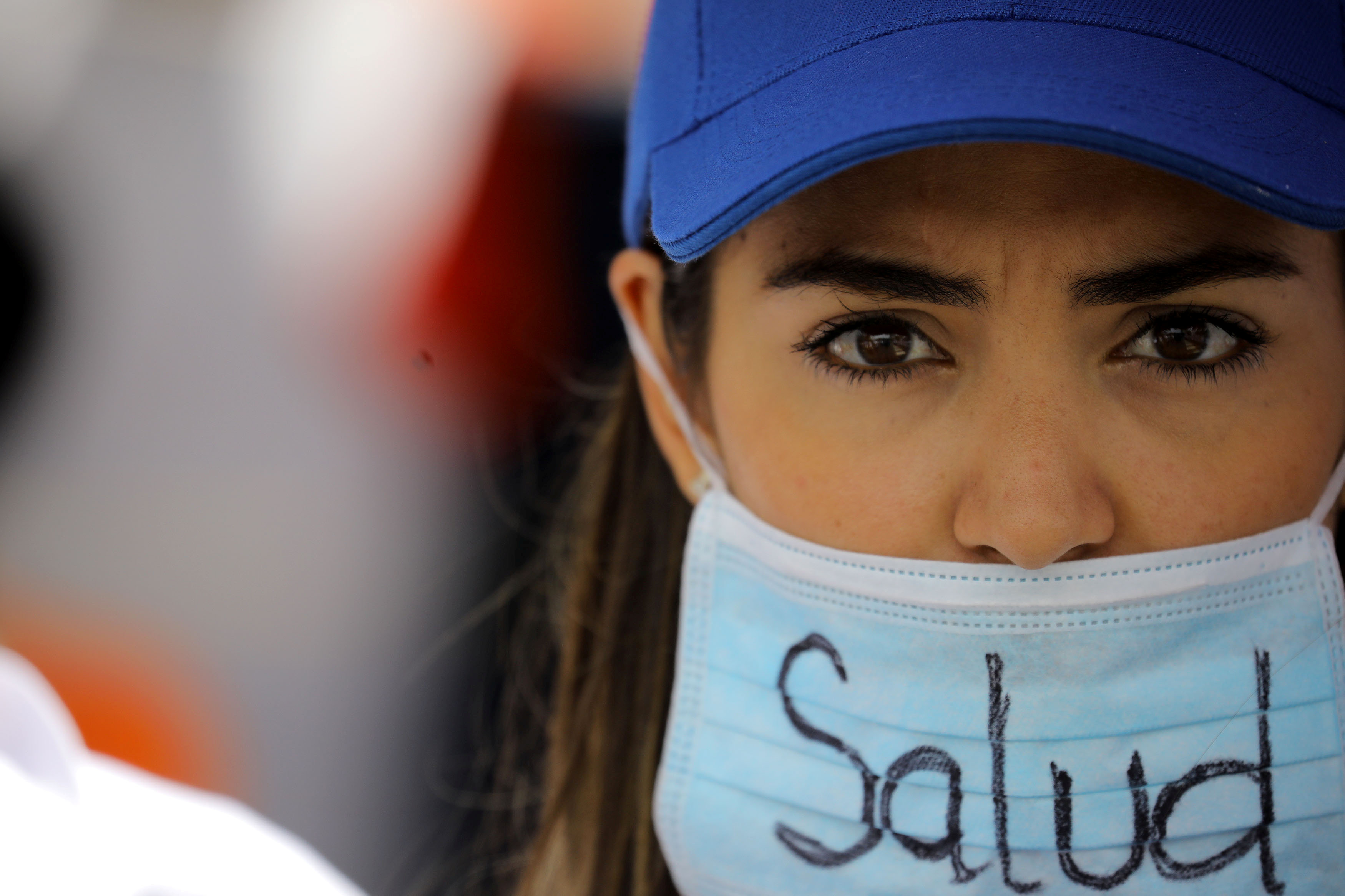 A demonstrator wears a mask that reads "Health" as she attends a rally called by health care workers and opposition activists against Venezuela's President Nicolas Maduro in Caracas, Venezuela May 22, 2017. REUTERS/Carlos Barria