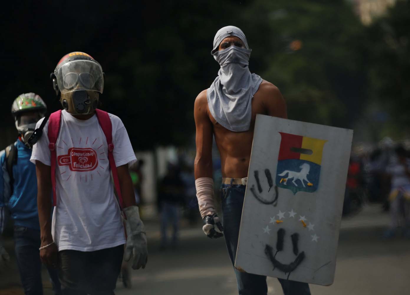 Demonstrators look on during a rally against President Nicolas Maduro in Caracas, Venezuela, May 24, 2017. REUTERS/Carlos Garcia Rawlins