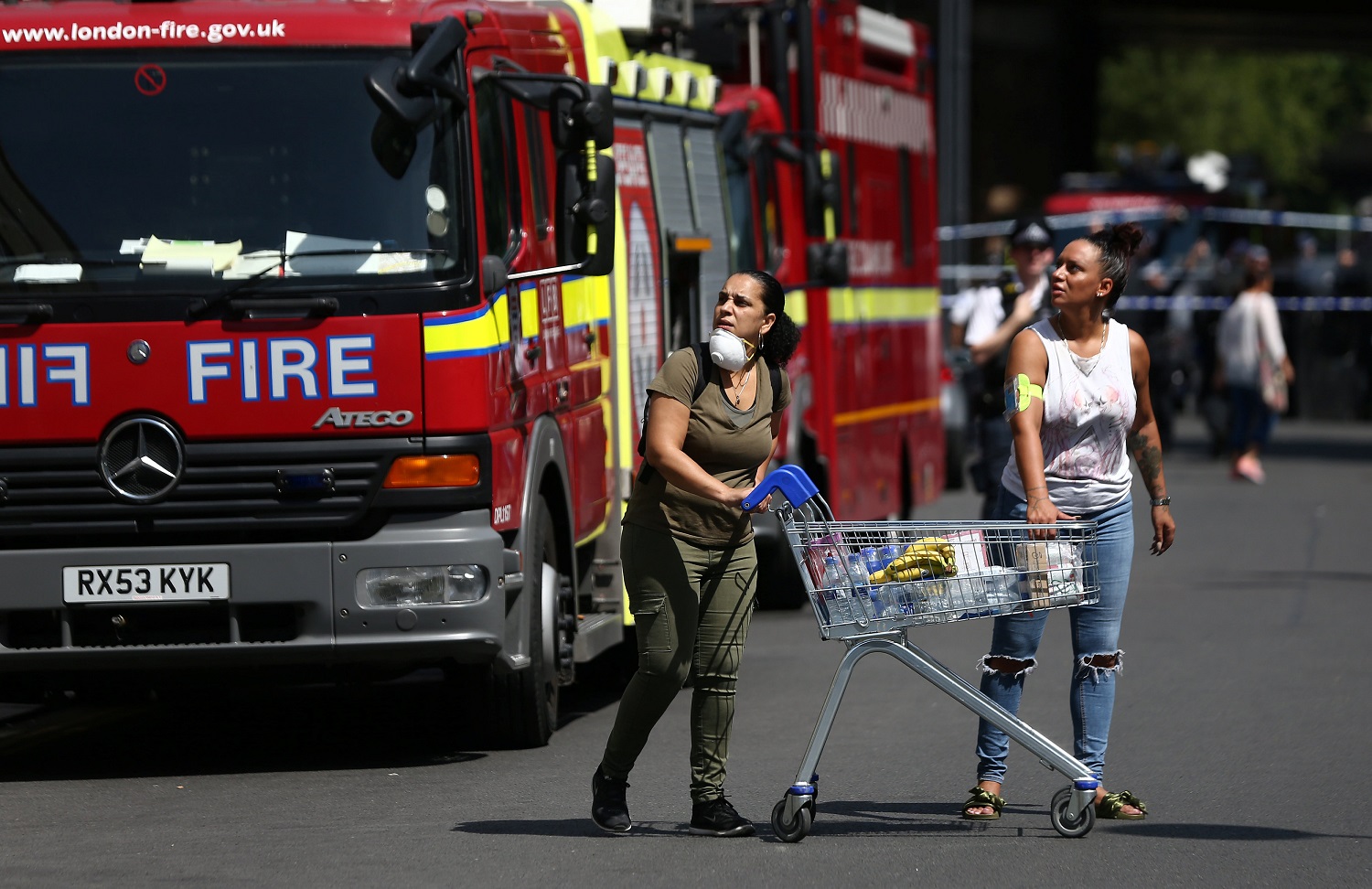 People react near a tower block severely damaged by a serious fire, in north Kensington, West London, Britain June 14, 2017. REUTERS/Neil Hall