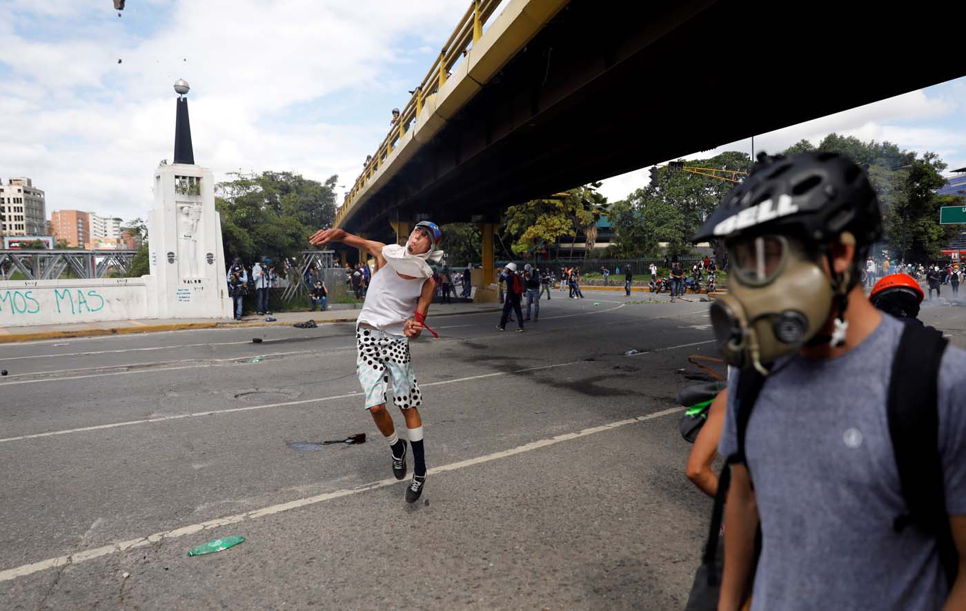 A demonstrator hurls stones during clashes with security forces at a rally against Venezuelan President Nicolas Maduro's government in Caracas, Venezuela, July 6, 2017. REUTERS/Andres Martinez Casares