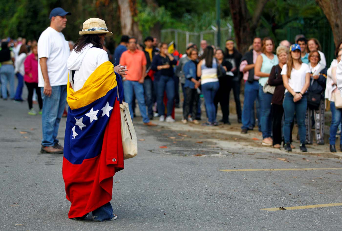 People stand in line to cast their vote at a polling station during an unofficial plebiscite against Venezuela's President Nicolas Maduro's government and his plan to rewrite the constitution, in Caracas, Venezuela July 16, 2017. REUTERS/Christian Veron