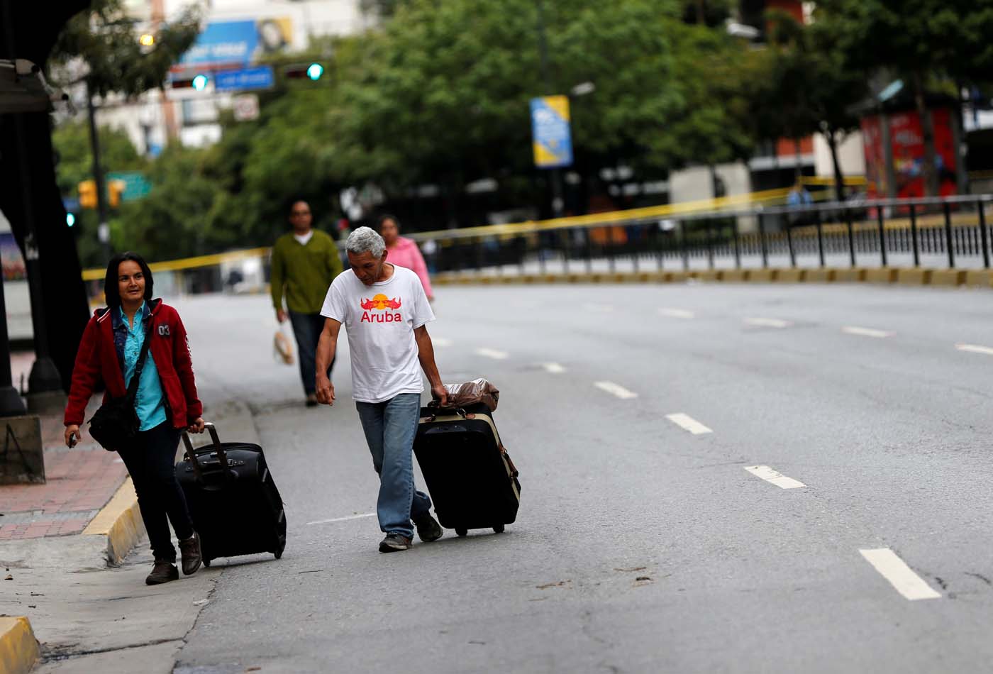 People walk along an empty road during a strike called to protest against Venezuelan President Nicolas Maduro's government in Caracas, Venezuela, July 20, 2017. REUTERS/Andres Martinez Casares