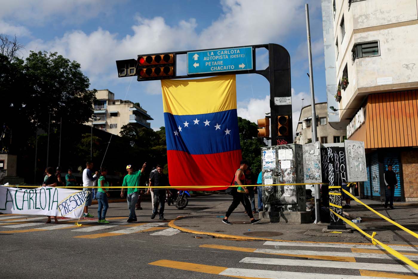 People walk along an empty street during a strike called to protest against Venezuelan President Nicolas Maduro's government in Caracas, Venezuela, July 20, 2017. REUTERS/Marco Bello