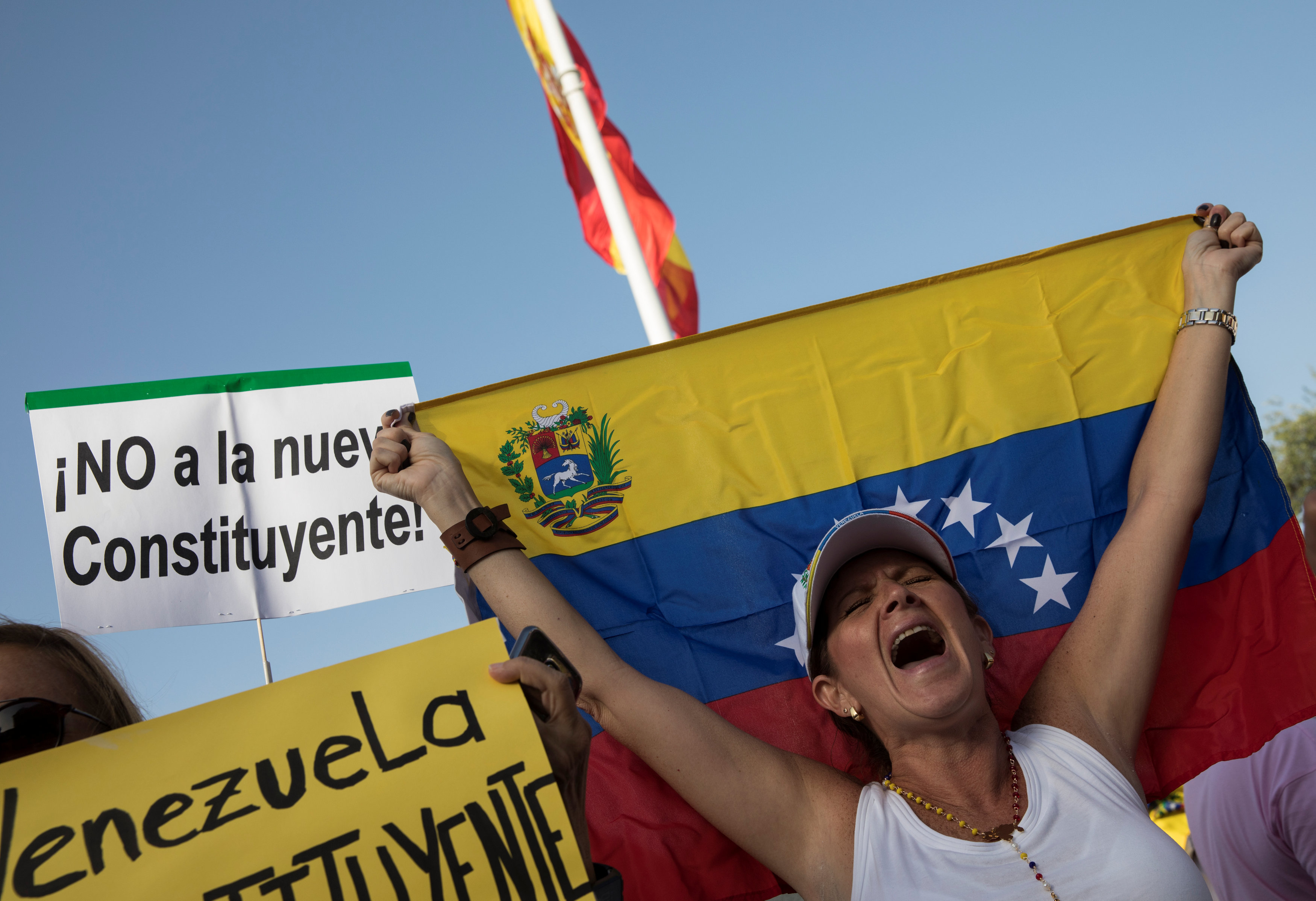 A woman shouts slogans during a protest held by Venezuelans in Spain against Venezuela's Constituent Assembly election, in Madrid, Spain, July 30, 2017. The placard reads in Spanish: "No to the new Constituent". REUTERS/Sergio Perez