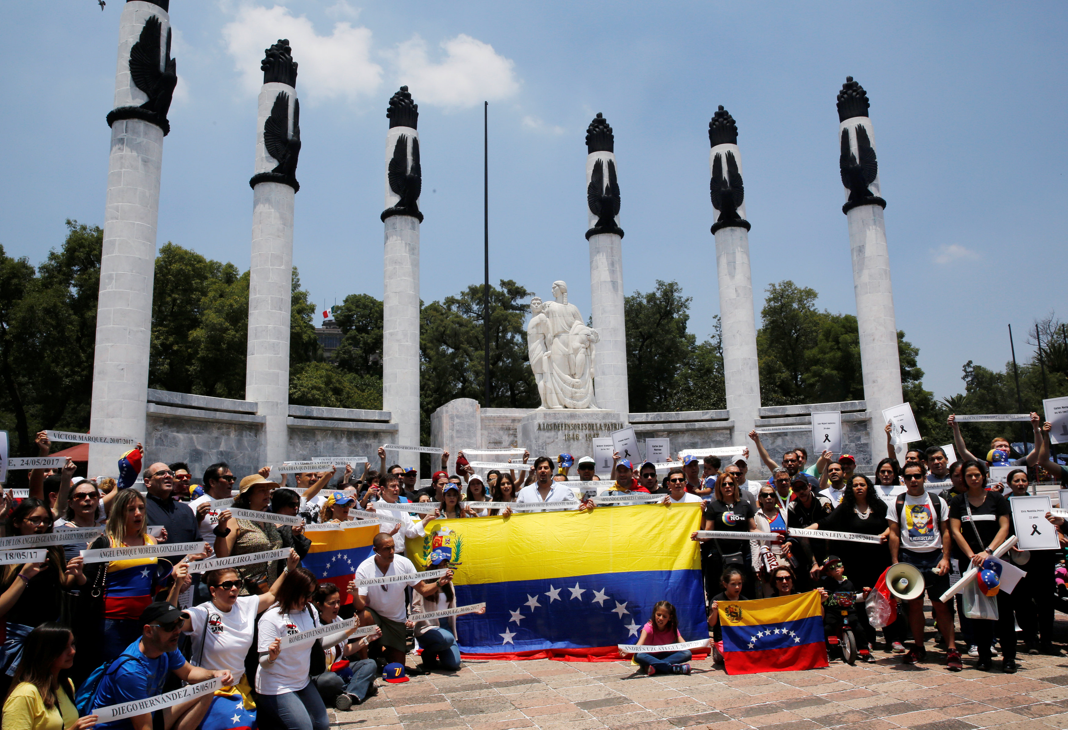 People hold Venezuela flags as they take part in a protest held by Venezuelans in Mexico against Venezuela's Constituent Assembly election, at the Heroic Children monument in Mexico City, Mexico  July 30, 2017. REUTERS/Henry Romero
