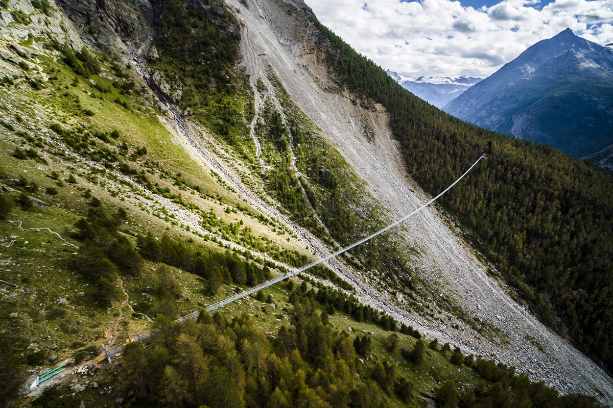 The "Europabruecke",  supposed to be the world's longest pedestrian suspension bridge with a length of 494m, is pictured one day prior to the official inauguration of the construction, in Randa, Switzerland, on Friday, July 28, 2017. The bridge is situated on the Europaweg, that connects the villages of Zermatt and Graechen. (Valentin Flauraud/Keystone via AP)