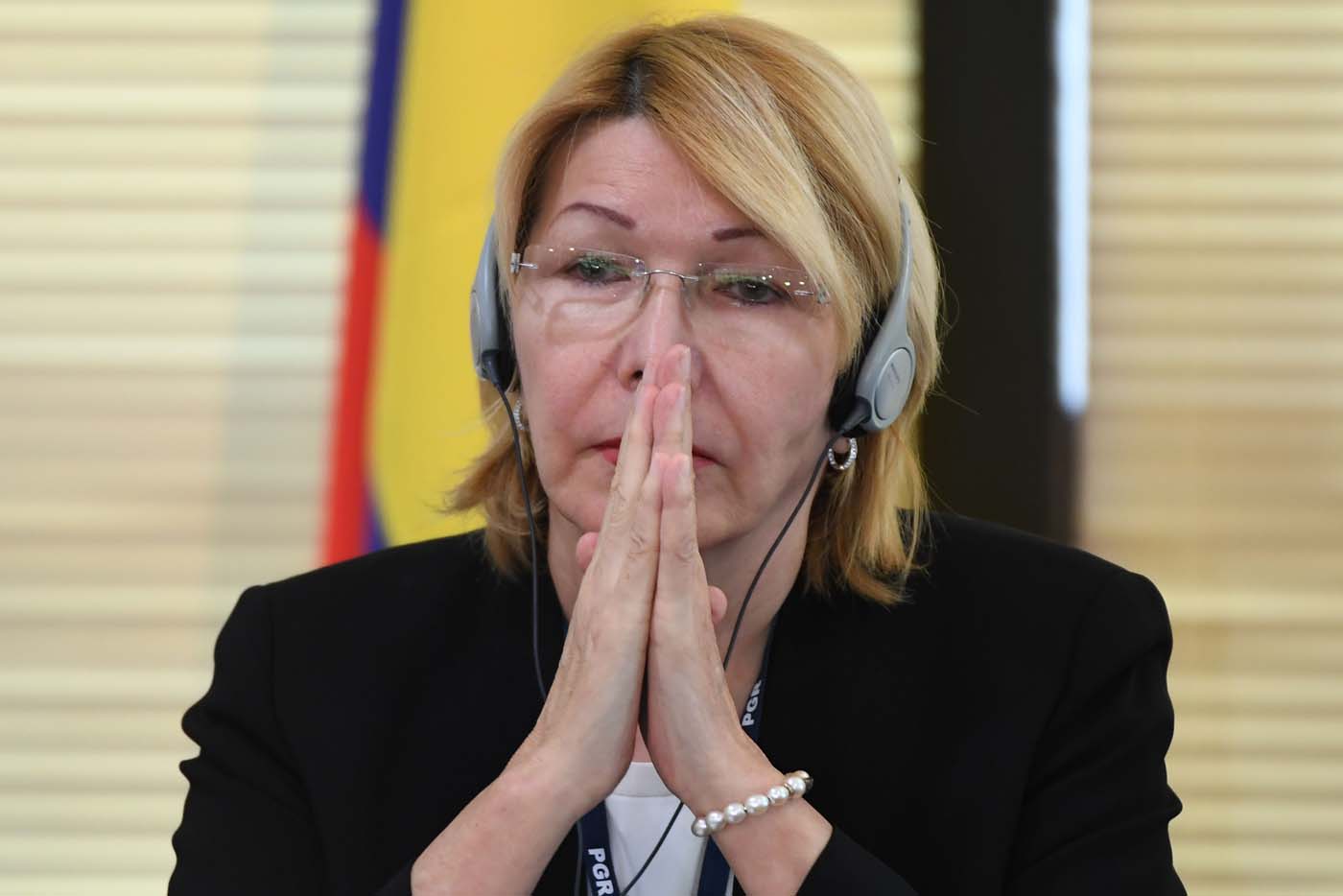 Venezuela's fugitive former top prosecutor Luisa Ortega, one of President Nicolas Maduro's most vocal critics, invited by Brazil's prosecutor general Rodrigo Janot, attends a conference with representatives from the Latin American regional trading alliance Mercosur, in Brasilia, on August 23, 2017. Ortega promised to use the international forum in Brazil to intensify corruption allegations against Maduro, who called for her arrest. Days after a dramatic escape from Venezuela, Ortega arrived in Brasilia promising to dish dirt on Maduro, who in turn asked Interpol to put out a "red notice" warrant for his critic. / AFP PHOTO / EVARISTO SA