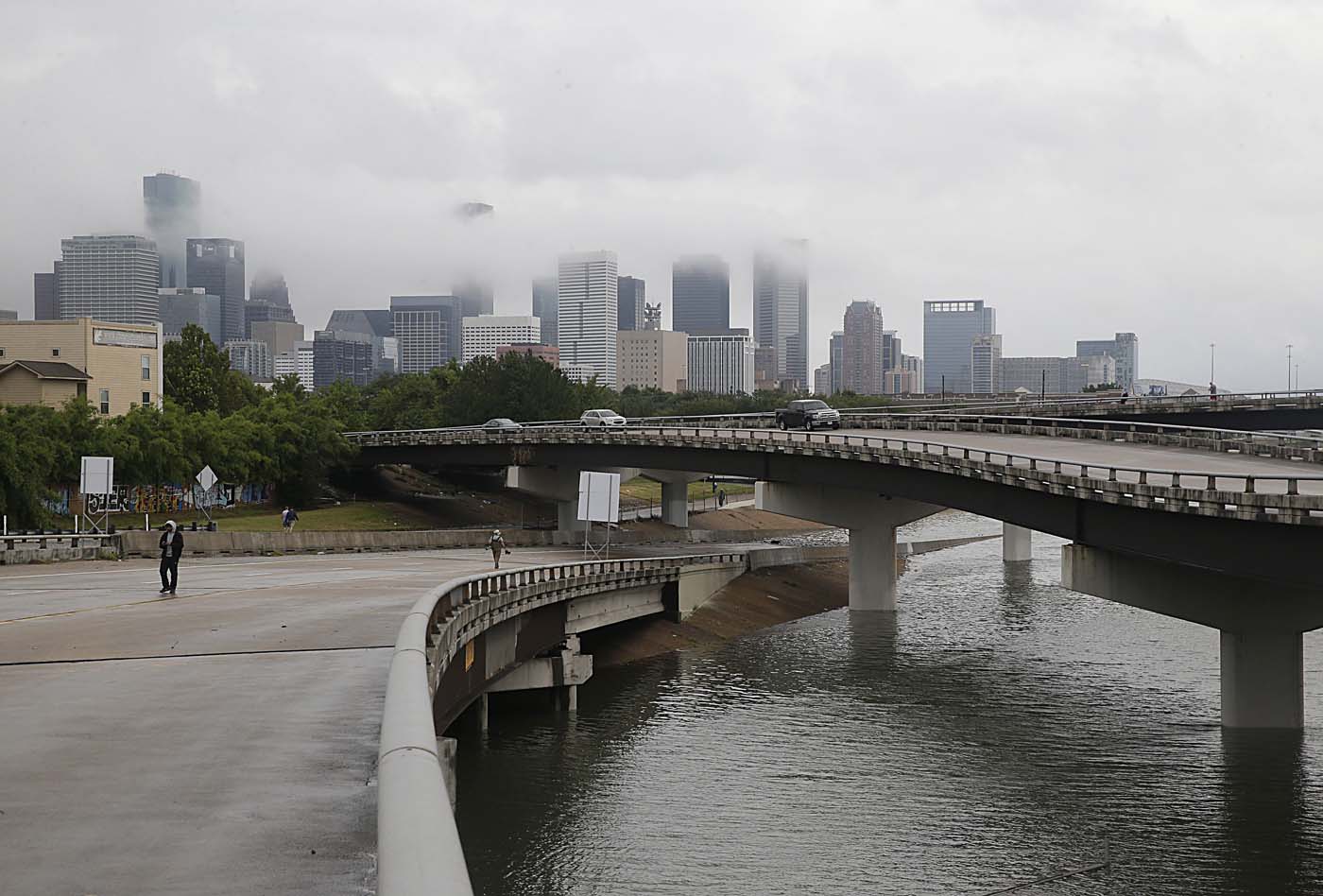 The downtown Houston skyline and flooded highway 288 are seen August 27, 2017 as the city battles with tropical storm Harvey and resulting floods. / AFP PHOTO / Thomas B. Shea