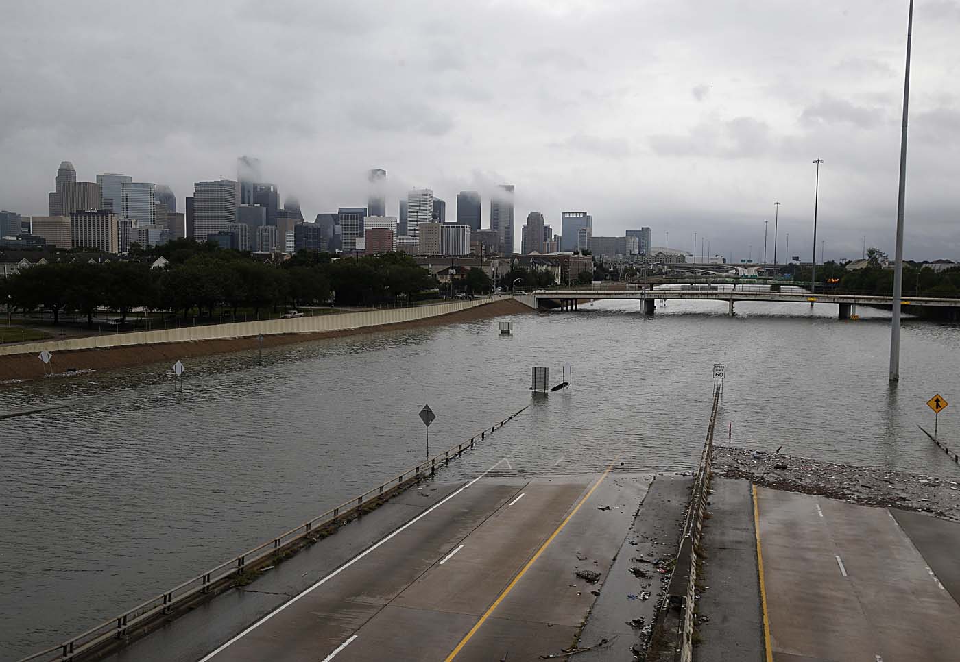 The downtown Houston skyline and flooded highway 288 are seen August 27, 2017 as the city battles with tropical storm Harvey and resulting floods. / AFP PHOTO / Thomas B. Shea