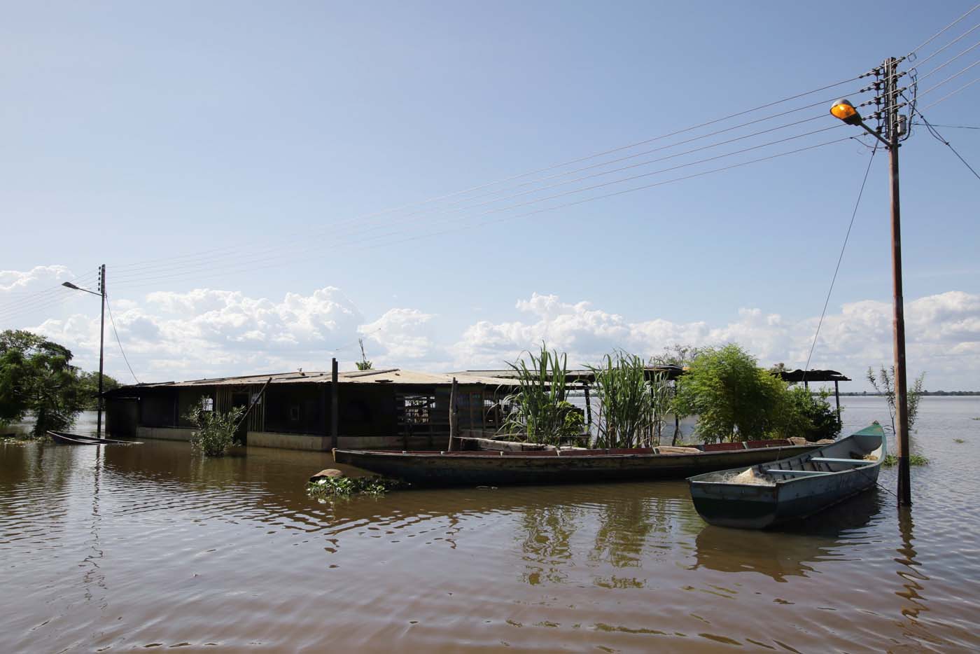 Boats are seen in a flooded street in Las Galderas, Venezuela, August 8, 2017. Picture taken August 8, 2017. REUTERS/William Urdaneta