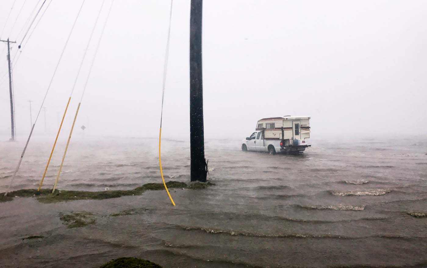 Craig "Cajun" Uggen, 57, nearly floods his truck as Hurricane Harvey comes ashore in Corpus Christi, Texas, U.S. August 25, 2017. Minutes later, high winds blew off the camper carrying all of his belongings. REUTERS/Brian Thevenot