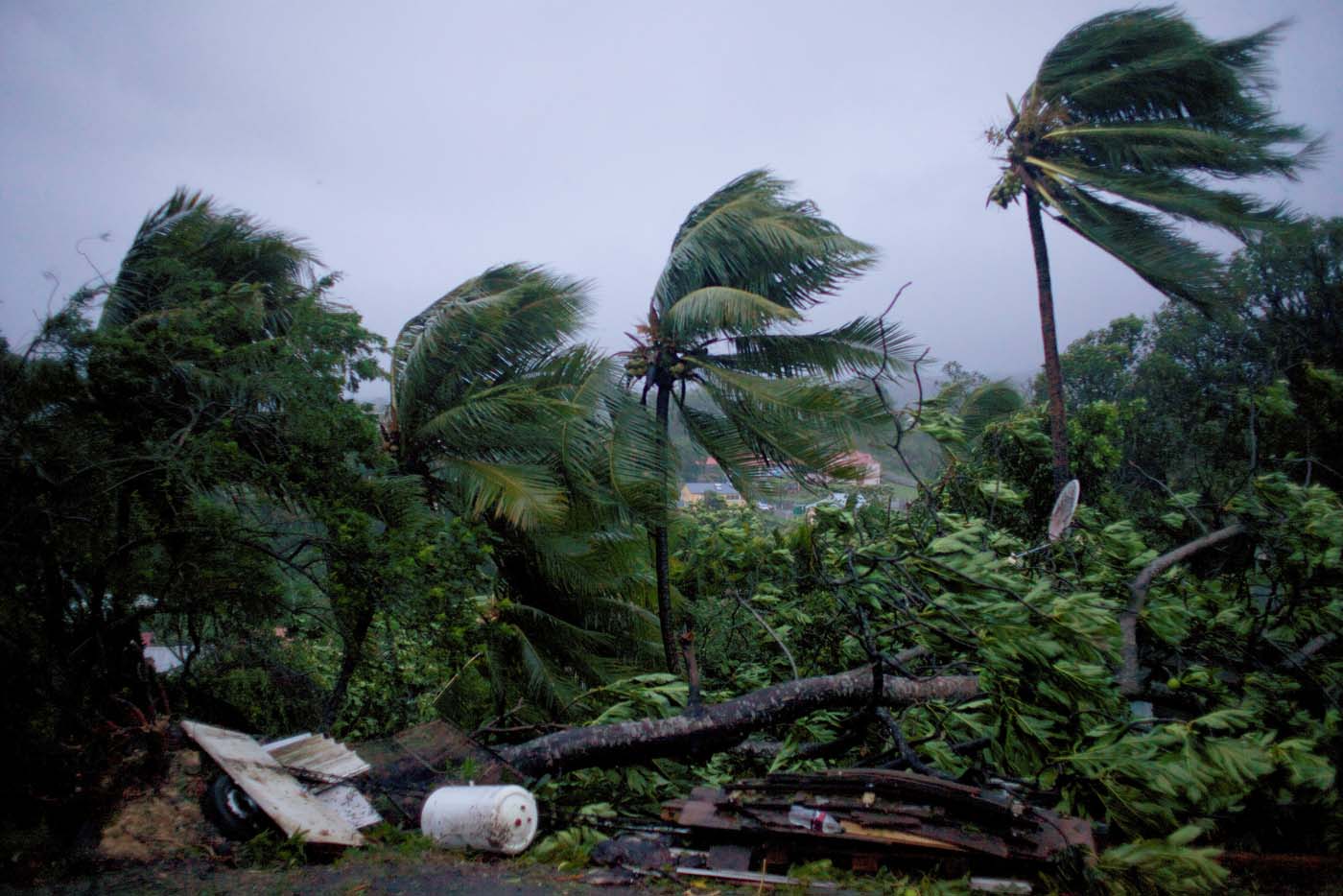 A picture taken on September 19, 2017 shows the powerful winds and rains of hurricane Maria battering the city of Petit-Bourg on the French overseas Caribbean island of Guadeloupe. Hurricane Maria strengthened into a "potentially catastrophic" Category Five storm as it barrelled into eastern Caribbean islands still reeling from Irma, forcing residents to evacuate in powerful winds and lashing rain. / AFP PHOTO / Cedrik-Isham Calvados /