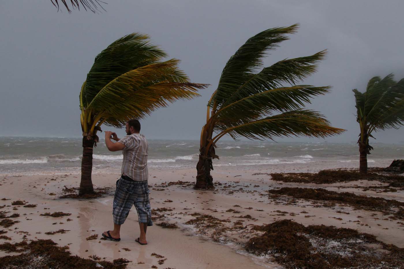 A man photographs the waves before the arrival of Hurricane Maria in Punta Cana, Dominican Republic, September 20, 2017. REUTERS/Ricardo Rojas