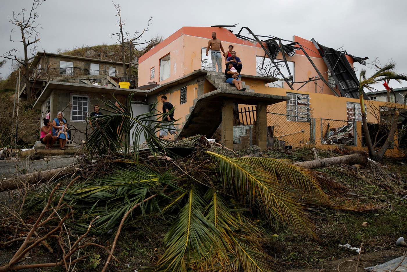 People rest outside a damaged house after the area was hit by Hurricane Maria in Yabucoa, Puerto Rico September 22, 2017. REUTERS/Carlos Garcia Rawlins TPX IMAGES OF THE DAY