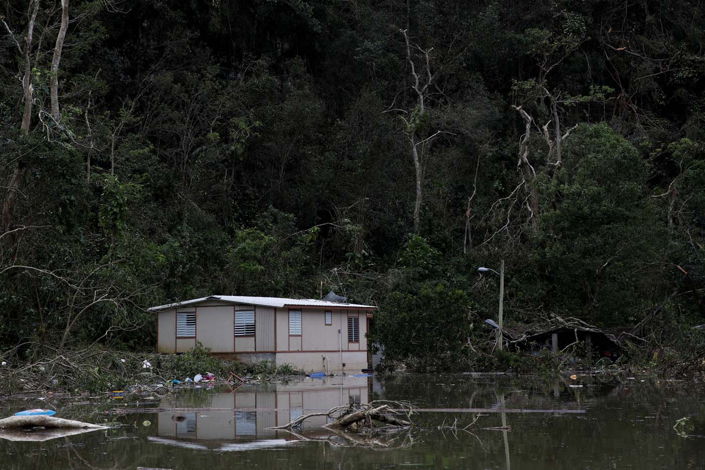 Houses damaged by flood waters are seen close to the dam of the Guajataca lake after the area was hit by Hurricane Maria in Guajataca, Puerto Rico September 23, 2017. REUTERS/Carlos Garcia Rawlins