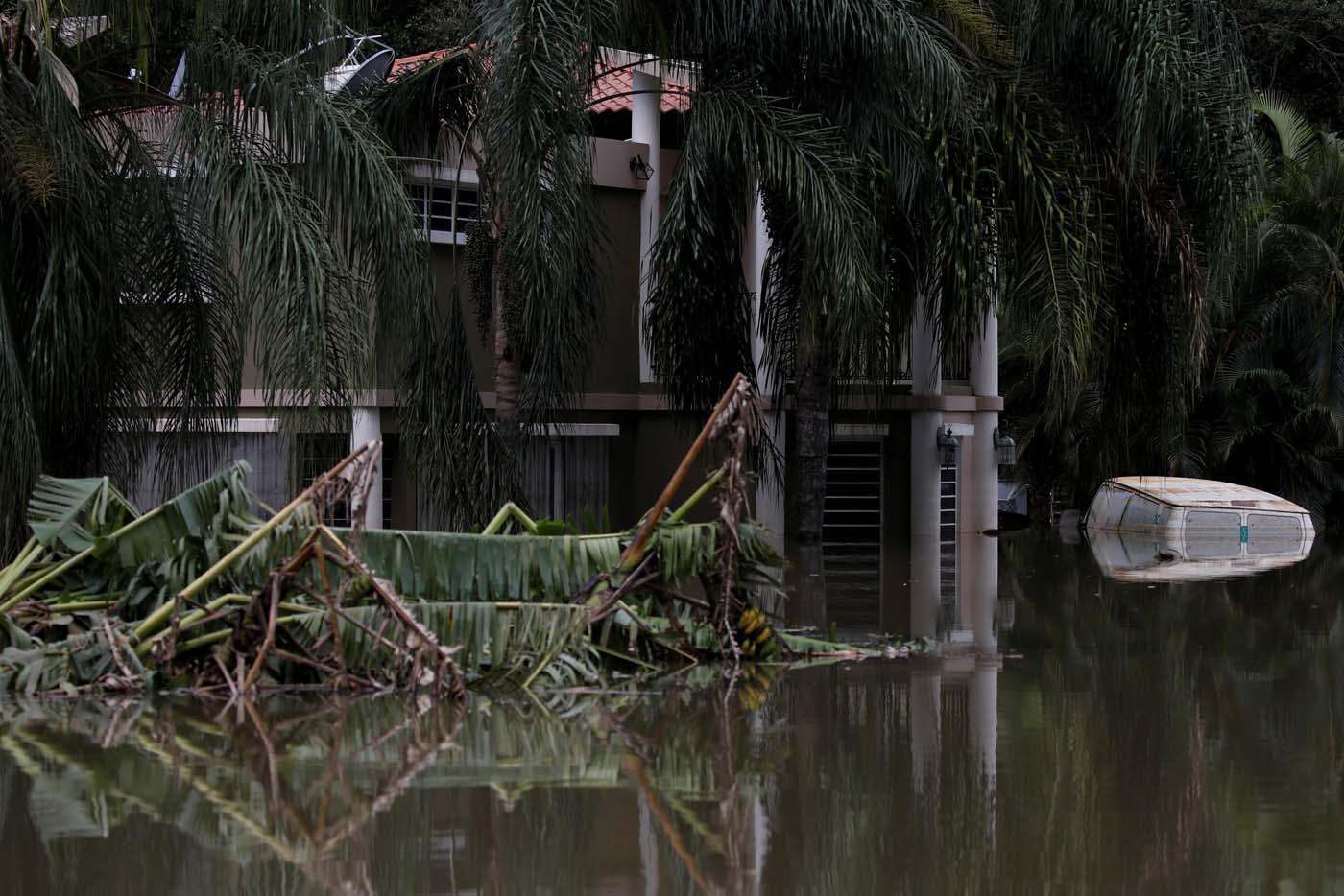 A house submerged by flood waters is seen close to the dam of the Guajataca lake after the area was hit by Hurricane Maria in Guajataca, Puerto Rico September 23, 2017. REUTERS/Carlos Garcia Rawlins