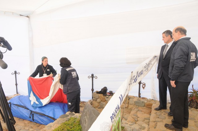 Chilean Judge Carroza and Director of Chile's Forensic Service Bustos, watch the coffin of Chilean poet Pablo Neruda, during the exhumation of his remains in Isla Negra