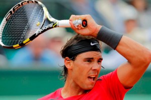 Nadal of Spain returns the ball to Istomin of Uzbekistan during the French Open tennis tournament at the Roland Garros stadium in Paris