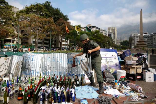 A national guard holds a bottle of molotov cocktail at Altamira square in Caracas