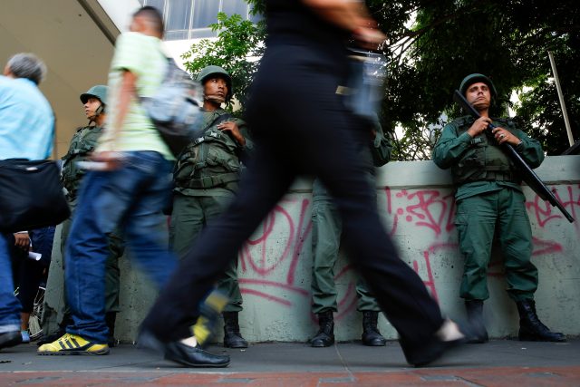 National Guards stand guard next to a metro station at Altamira square in Caracas