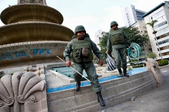 National Guards carry materials used during protest at Altamira square in Caracas
