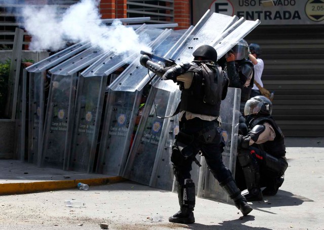 Police fire teargas at anti-government protesters demonstrating against Maduro's government in Caracas