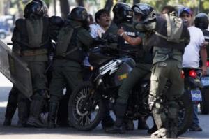 National guards detain anti-government protesters demonstrating against Maduro's government in Caracas