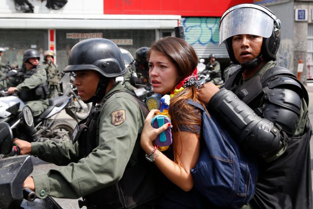 National guards detain an anti-government protester on a motorcycle during a protest in Caracas