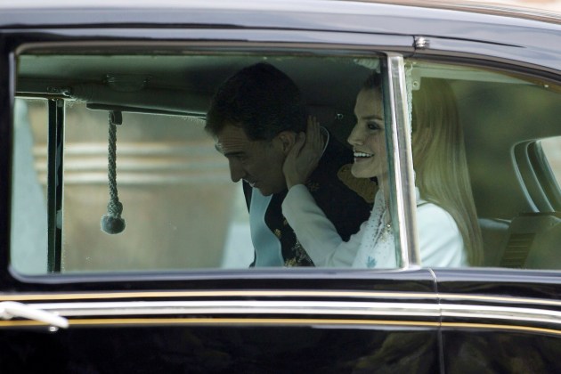 Queen Letizia touches the cheek of Spain's new King Felipe VI as they sit in their car while leaving the Zarzuela Palace to the Congress of Deputies in Madrid
