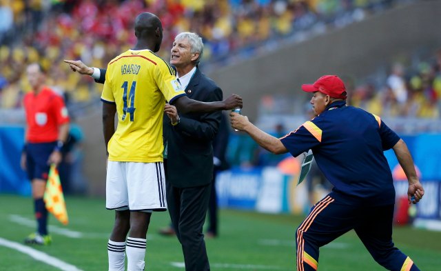 Colombia's Ibarbo takes a drink as he receives instructions from coach Jose Pekerman during their 2014 World Cup Group C soccer match against Greece at the Mineirao stadium in Belo Horizonte