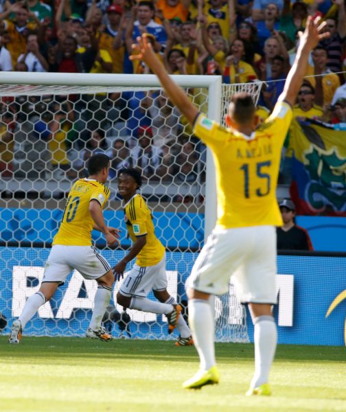 Colombia's James Rodriguez, Colombia's Juan Cuadrado and Colombia's Alexander Mejia celebrate after Colombia's third goal during their 2014 World Cup Group C soccer match at the Mineirao stadium in Belo Horizonte