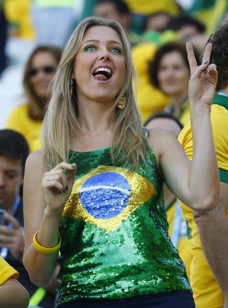 A fan poses before the opening ceremony of the 2014 World Cup at the Corinthians arena in Sao Paulo