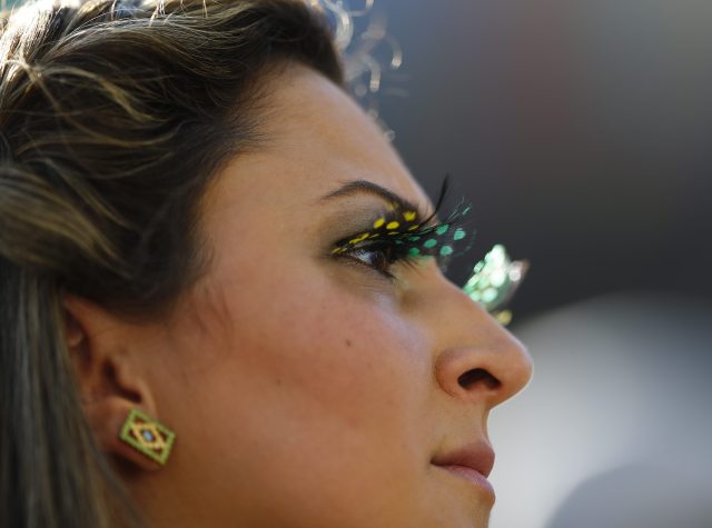 A Brazilian fan waits for the start of the opening ceremony of the 2014 World Cup at the Corinthians arena in Sao Paulo