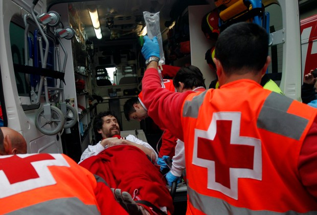 Runner is lifted into an ambulance after falling down and being gored during the third running of the bulls of the San Fermin festival in Pamplona