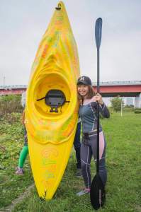 Japanese artist Megumi Igarashi, known as Rokudenashiko, poses with her kayak modeled on her vagina at the Tama river in Tokyo