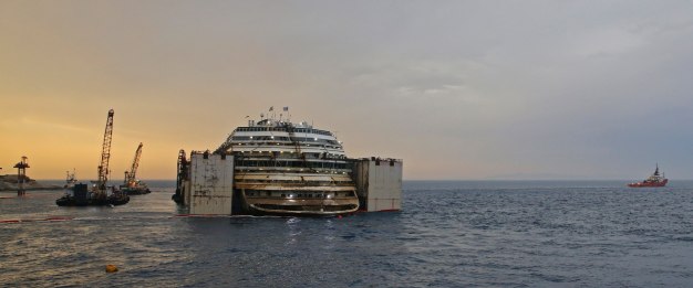The Costa Concordia cruise liner is pictured from a ferry as it emerges during the refloating operation at Giglio harbour