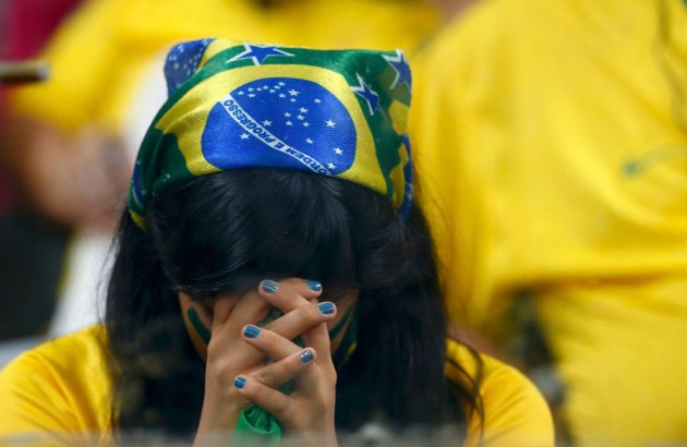 A Brazil fan reacts during the 2014 World Cup semi-finals between Brazil and Germany at the Mineirao stadium