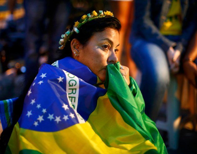 Brazil fans react as they watch their 2014 World Cup semi-finals against Germany on a street in Rio de Janeiro