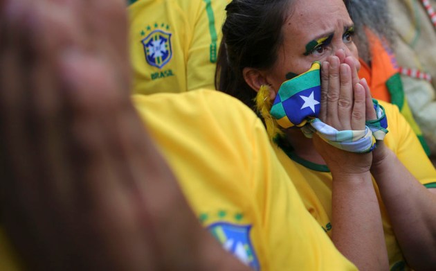 A Brazilian soccer fan reacts as she watches the 2014 World Cup semi- final soccer match between Brazil and Germany in Sao Paulo