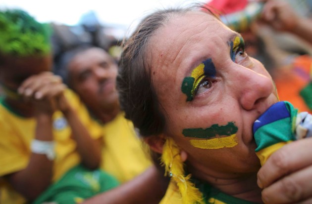 A Brazilian soccer fan cries as she watches the 2014 World Cup semi- final soccer match between Brazil and Germany in Sao Paulo