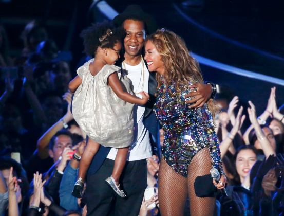 Beyonce smiles with Jay-Z and daughter Ivy Blue after accepting the Video Vanguard Award on stage during the 2014 MTV Video Music Awards in Inglewood