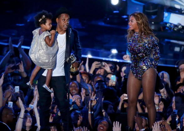Jay-Z presents the Video Vanguard Award to his wife Beyonce as he holds their daughter Ivy Blue during the 2014 MTV Video Music Awards in Inglewood