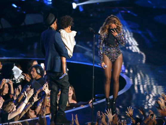 Beyonce reacts as her husband Jay-Z carries their daughter Ivy Blue onstage to present the Video Vanguard Award during the 2014 MTV Video Music Awards in Inglewood