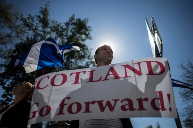 A man holds a placard during a rally in support of Scotland's independence referendum, in Donetsk