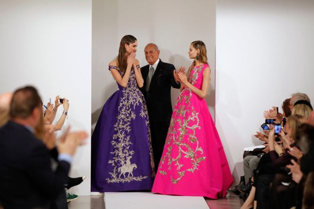 File photo of designer Oscar De La Renta with models after presenting his Autumn/Winter 2013 collection during New York Fashion Week