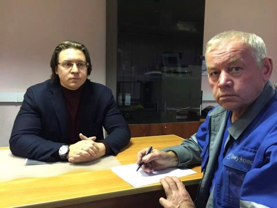 Vladimir Martynenko signs his testimony before his lawyer Alexander Karabanov in Moscow