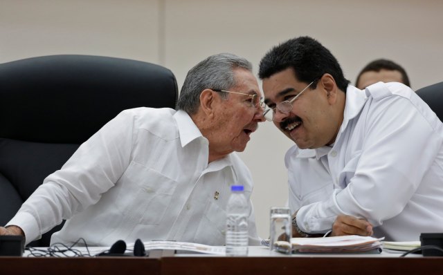 Cuba's President Castro talks to his Venezuelan counterpart Maduro during the opening ceremony of the ALBA-TCP Extraordinary Ebola summit in Havana
