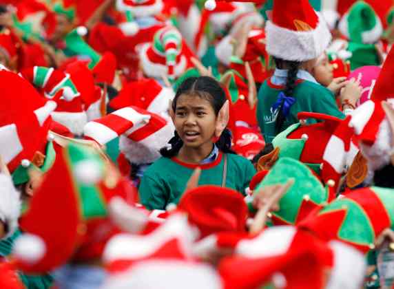 Students gather to break the Guinness World Record, for dressing as Santa's elves, in Bangkok